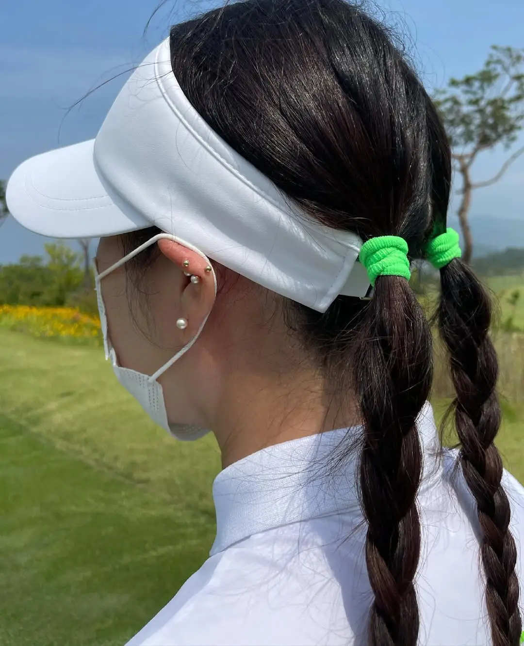30 Sleek Golf Hairstyles: Polished and Practical Styles for Game Day Glam 16 #15. Double Low Braids with Neon Bands and Visor