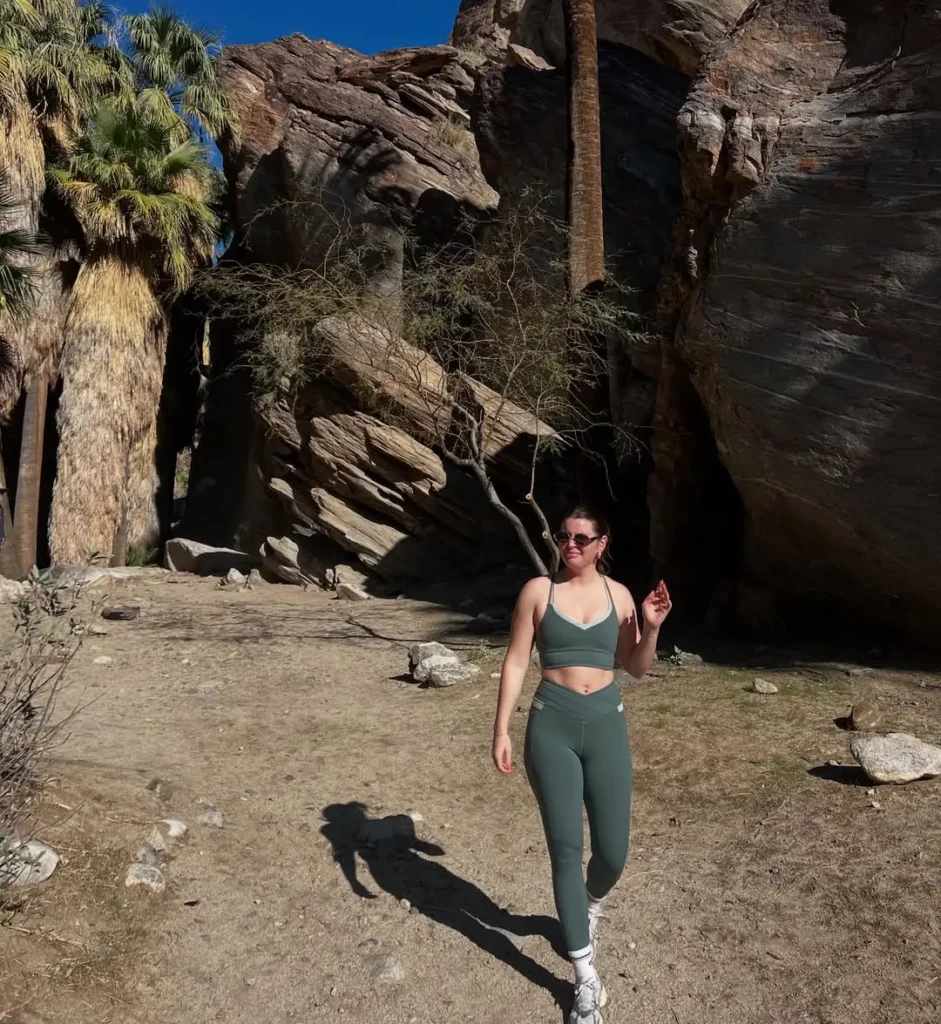 #15. Sage Green Activewear Set with White Trainers and Cat-Eye Sunglasses