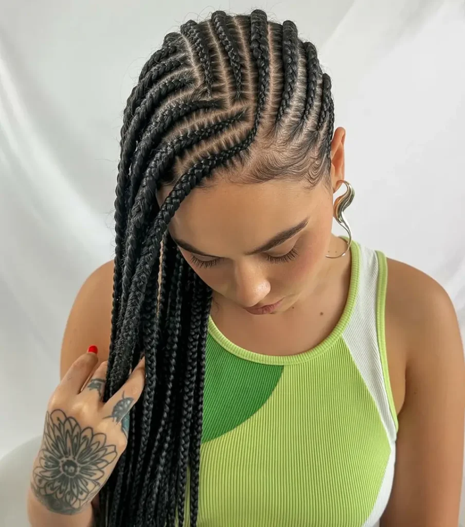 #16. Side-Swept Cornrow Braids with Sculpted Edges