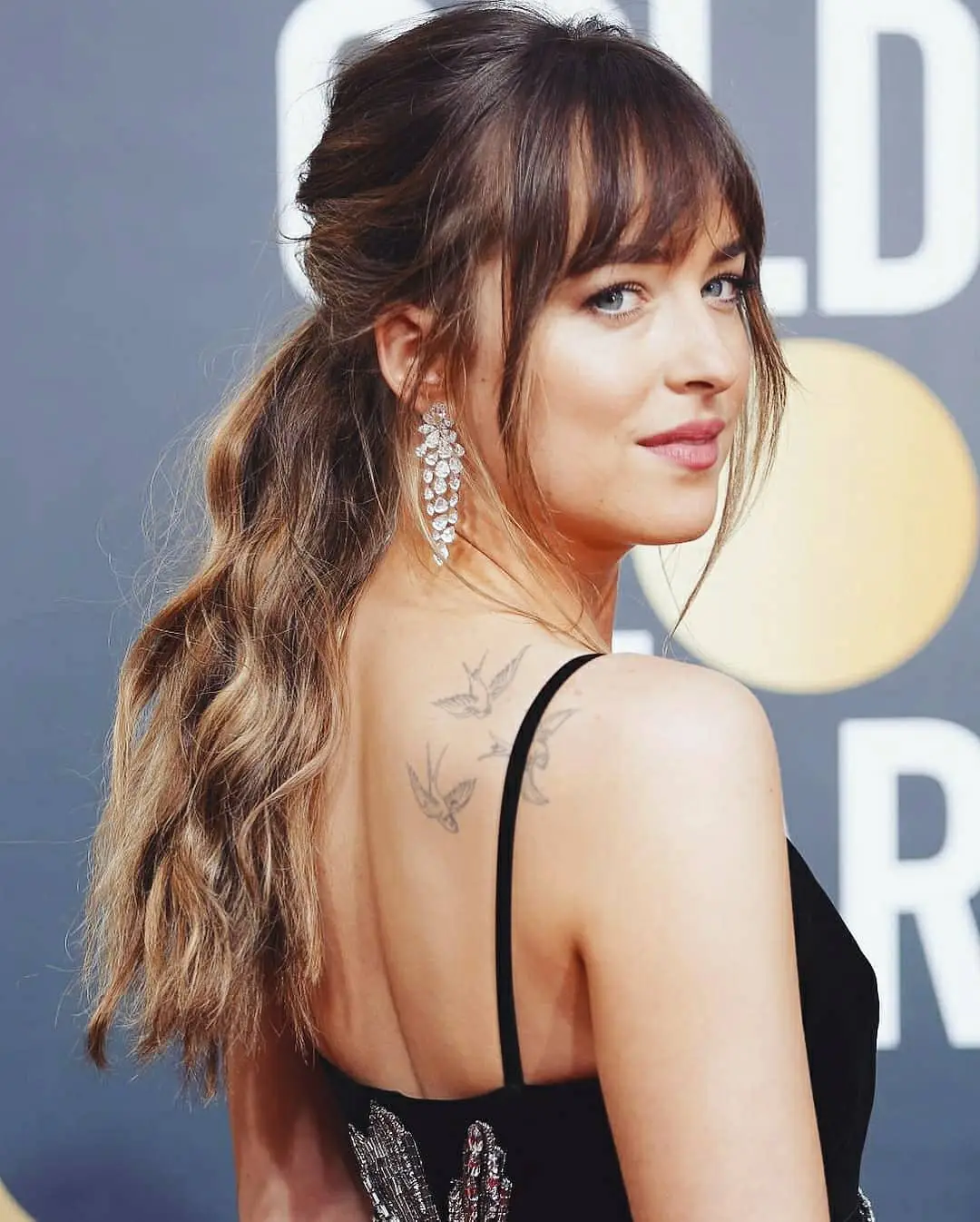 #20. Loose Wavy Ponytail with Wispy Bangs