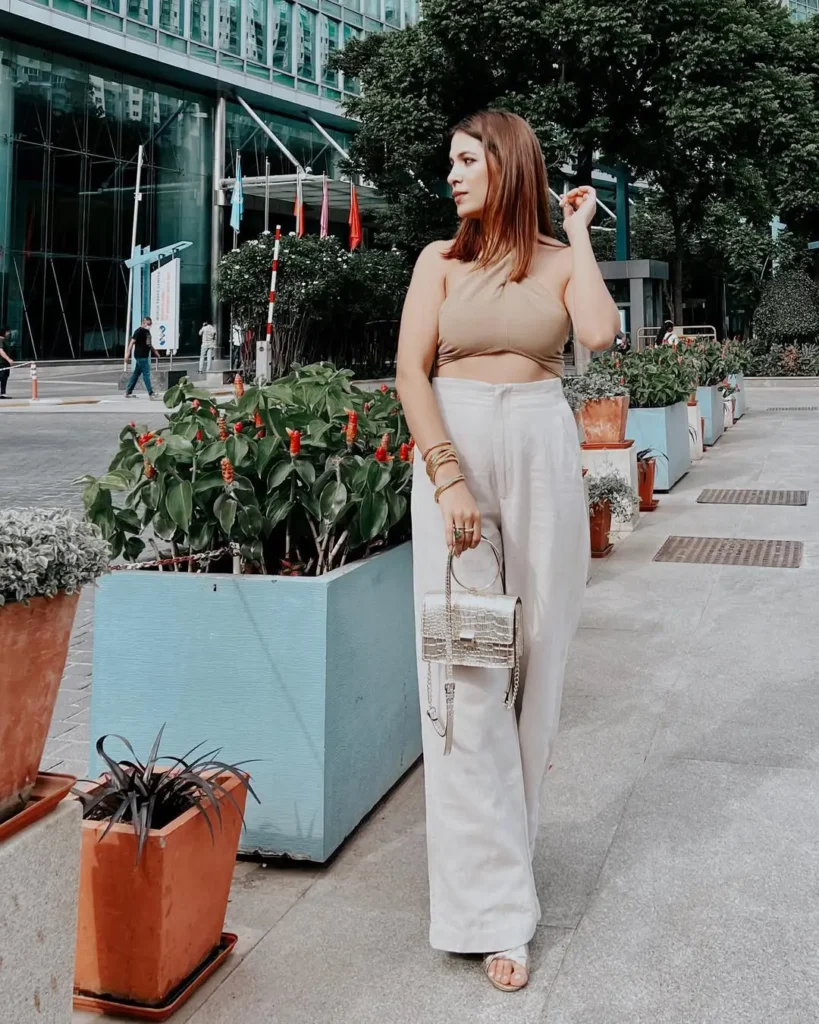 #6. Beige Halter Crop Top with White Wide-Leg Pants and Metallic Mini Bag
