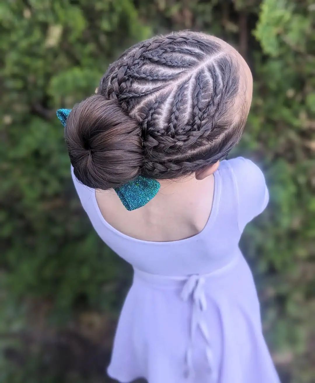 26 Bold Dance Hairstyles: Show-Stopping Styles for Stage and Studio 17 Braided Sunburst Bun with Sparkle Bow Accent