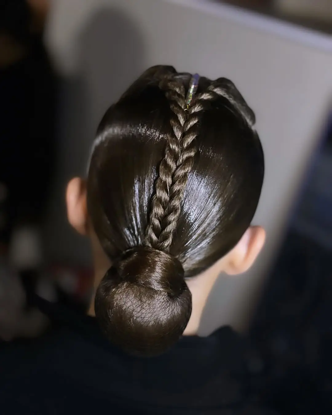 26 Bold Dance Hairstyles: Show-Stopping Styles for Stage and Studio 21 Center Braid Sleek Bun for Ballroom Precision